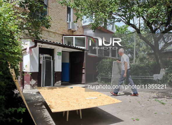 A man is walking outside an apartment block after a Russian missile attack in Vasylkiv, Ukraine, on June 23, 2024. On Sunday morning, June 2...