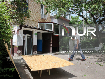 A man is walking outside an apartment block after a Russian missile attack in Vasylkiv, Ukraine, on June 23, 2024. On Sunday morning, June 2...