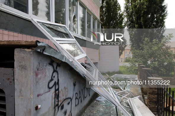 Knocked-out windows are lying on the ground outside an apartment block after a Russian missile attack in Vasylkiv, Ukraine, on June 23, 2024...