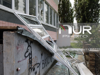 Knocked-out windows are lying on the ground outside an apartment block after a Russian missile attack in Vasylkiv, Ukraine, on June 23, 2024...