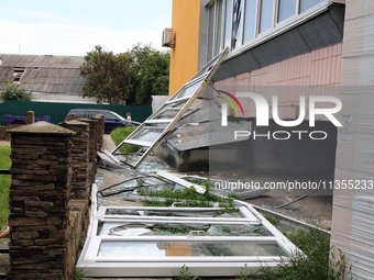 Knocked-out windows are lying on the ground outside an apartment block after a Russian missile attack in Vasylkiv, Ukraine, on June 23, 2024...