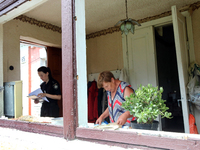 A police officer is helping a woman record the damage after a Russian missile attack in Vasylkiv, Ukraine, on June 23, 2024. On Sunday morni...