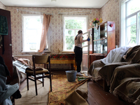 A woman is removing a knocked-out window frame in a house after a Russian missile attack in Vasylkiv, Ukraine, on June 23, 2024. On Sunday m...