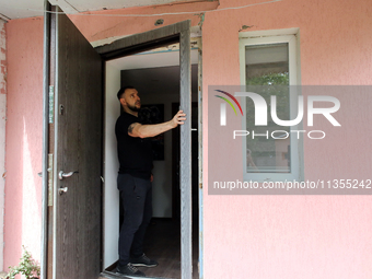 A man is examining a knocked-out door in a house damaged by a Russian missile attack in Vasylkiv, Ukraine, on June 23, 2024. On Sunday morni...