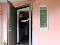 A man is examining a knocked-out door in a house damaged by a Russian missile attack in Vasylkiv, Ukraine, on June 23, 2024. On Sunday morni...