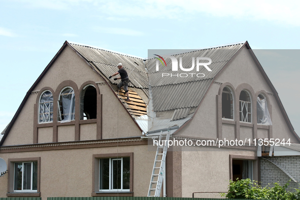 A man is repairing the roof of a house damaged by a Russian missile attack in Vasylkiv, Ukraine, on June 23, 2024. On Sunday morning, June 2...