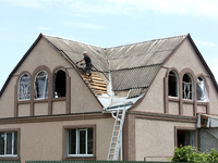 A man is repairing the roof of a house damaged by a Russian missile attack in Vasylkiv, Ukraine, on June 23, 2024. On Sunday morning, June 2...