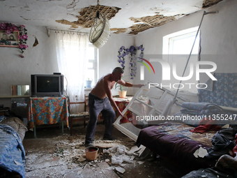 A man is removing the debris inside a house after a Russian missile attack in Vasylkiv, Ukraine, on June 23, 2024. On Sunday morning, June 2...