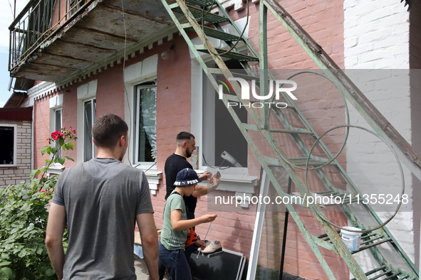 People are being pictured outside a house damaged by a Russian missile attack in Vasylkiv, Ukraine, on June 23, 2024. On Sunday morning, Jun...