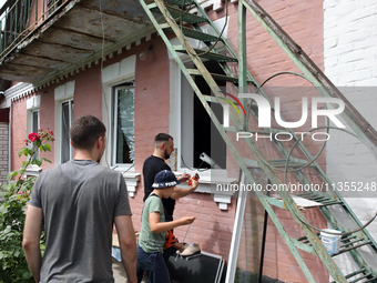 People are being pictured outside a house damaged by a Russian missile attack in Vasylkiv, Ukraine, on June 23, 2024. On Sunday morning, Jun...