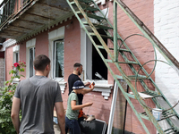 People are being pictured outside a house damaged by a Russian missile attack in Vasylkiv, Ukraine, on June 23, 2024. On Sunday morning, Jun...