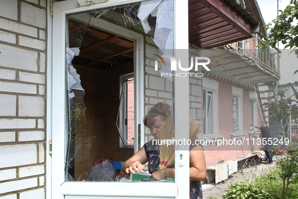 A woman is removing broken glass at a house after a Russian missile attack in Vasylkiv, Ukraine, on June 23, 2024. On Sunday morning, June 2...