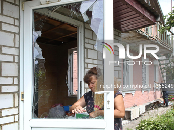 A woman is removing broken glass at a house after a Russian missile attack in Vasylkiv, Ukraine, on June 23, 2024. On Sunday morning, June 2...