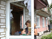 A woman is removing broken glass at a house after a Russian missile attack in Vasylkiv, Ukraine, on June 23, 2024. On Sunday morning, June 2...