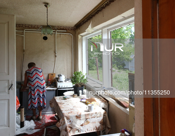 A woman is being seen inside a house damaged by a Russian missile attack in Vasylkiv, Ukraine, on June 23, 2024. On Sunday morning, June 23,...