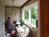 A woman is being seen inside a house damaged by a Russian missile attack in Vasylkiv, Ukraine, on June 23, 2024. On Sunday morning, June 23,...