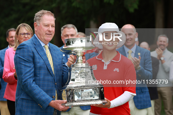 Amy Yang of Republic of Korea is presented with the trophy by the president of the PGA John Lindert after winning the KPMG Women's PGA Champ...