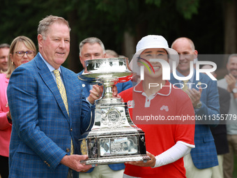 Amy Yang of Republic of Korea is presented with the trophy by the president of the PGA John Lindert after winning the KPMG Women's PGA Champ...