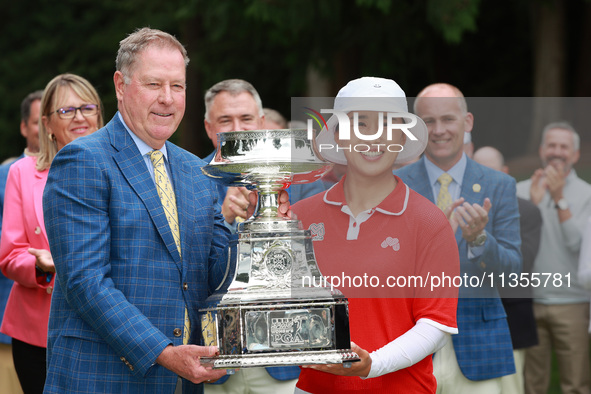 Amy Yang of Republic of Korea is presented with the trophy by the president of the PGA John Lindert after winning the KPMG Women's PGA Champ...