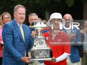 Amy Yang of Republic of Korea is presented with the trophy by the president of the PGA John Lindert after winning the KPMG Women's PGA Champ...