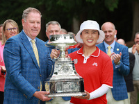 Amy Yang of Republic of Korea is presented with the trophy by the president of the PGA John Lindert after winning the KPMG Women's PGA Champ...