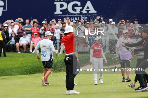 Amy Yang of Republic of Korea is showered with sparkling wine by her peers after winning the KPMG Women's PGA Championship at Sahalee Countr...