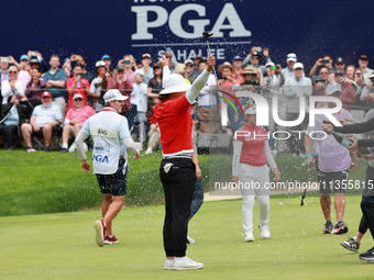 Amy Yang of Republic of Korea is showered with sparkling wine by her peers after winning the KPMG Women's PGA Championship at Sahalee Countr...