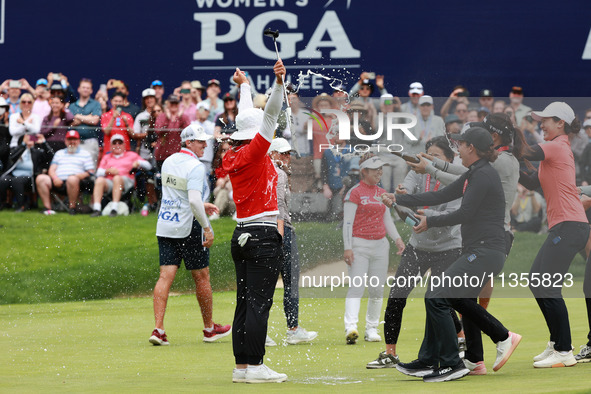 Amy Yang of Republic of Korea is showered with sparkling wine by her peers after winning the KPMG Women's PGA Championship at Sahalee Countr...