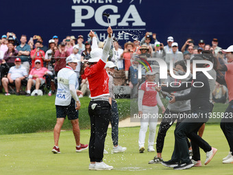 Amy Yang of Republic of Korea is showered with sparkling wine by her peers after winning the KPMG Women's PGA Championship at Sahalee Countr...