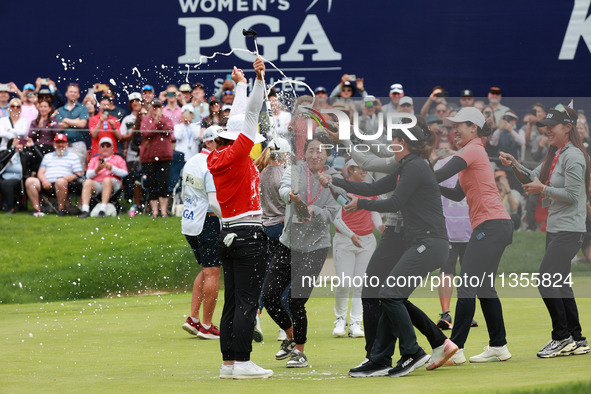 Amy Yang of Republic of Korea is showered with sparkling wine by her peers after winning the KPMG Women's PGA Championship at Sahalee Countr...