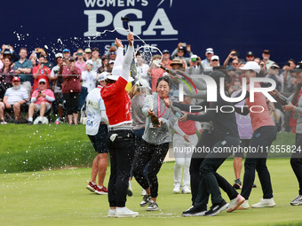 Amy Yang of Republic of Korea is showered with sparkling wine by her peers after winning the KPMG Women's PGA Championship at Sahalee Countr...