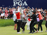 Amy Yang of Republic of Korea is showered with sparkling wine by her peers after winning the KPMG Women's PGA Championship at Sahalee Countr...