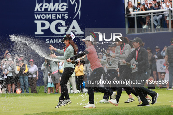 A group of professional golfers go to shower Amy Yang of Republic of Korea with sparkling wine after winning the KPMG Women's PGA Championsh...