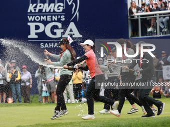 A group of professional golfers go to shower Amy Yang of Republic of Korea with sparkling wine after winning the KPMG Women's PGA Championsh...