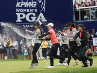 A group of professional golfers go to shower Amy Yang of Republic of Korea with sparkling wine after winning the KPMG Women's PGA Championsh...