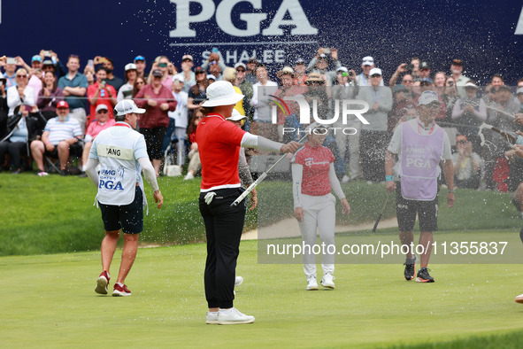 Amy Yang of Republic of Korea is showered with sparkling wine by her peers after winning the KPMG Women's PGA Championship at Sahalee Countr...