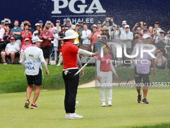 Amy Yang of Republic of Korea is showered with sparkling wine by her peers after winning the KPMG Women's PGA Championship at Sahalee Countr...