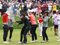 Amy Yang of Republic of Korea receives a celebratory sparkling wine shower by fellow professional golfers during the awards ceremony after w...