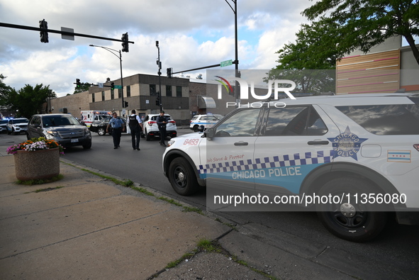 Police are present at the crime scene. Three people are shot, with one person pronounced dead, one person in critical condition, and one per...