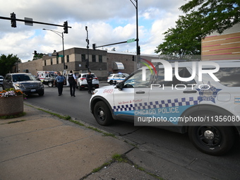 Police are present at the crime scene. Three people are shot, with one person pronounced dead, one person in critical condition, and one per...