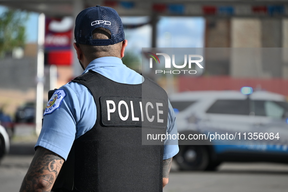 A Chicago Police Department officer is standing watch at the crime scene. Three people are being shot, with one person being pronounced dead...