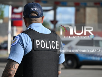 A Chicago Police Department officer is standing watch at the crime scene. Three people are being shot, with one person being pronounced dead...