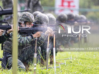 Special forces soldiers are performing an automatic rifle firing test on fixed targets in Baise, Guangxi province, China, on June 20, 2024....