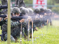 Special forces soldiers are performing an automatic rifle firing test on fixed targets in Baise, Guangxi province, China, on June 20, 2024....