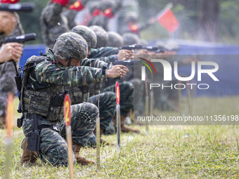 Special forces soldiers are performing an automatic rifle firing test on fixed targets in Baise, Guangxi province, China, on June 20, 2024....