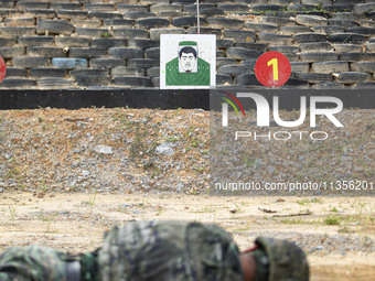 Special forces soldiers are performing an automatic rifle firing test on fixed targets in Baise, Guangxi province, China, on June 20, 2024....