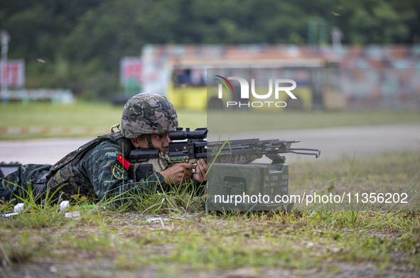 Special forces soldiers are performing an automatic rifle firing test on fixed targets in Baise, Guangxi province, China, on June 20, 2024. 