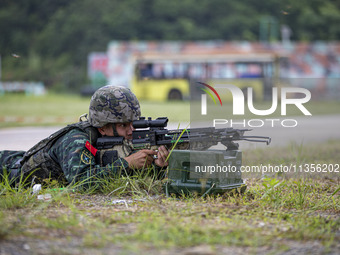 Special forces soldiers are performing an automatic rifle firing test on fixed targets in Baise, Guangxi province, China, on June 20, 2024....