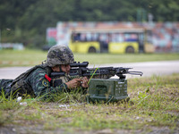 Special forces soldiers are performing an automatic rifle firing test on fixed targets in Baise, Guangxi province, China, on June 20, 2024....