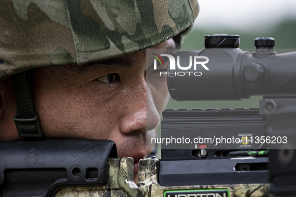 Special forces soldiers are performing an automatic rifle firing test on fixed targets in Baise, Guangxi province, China, on June 20, 2024. 